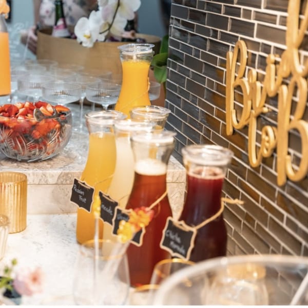 Peruvian beverages like Chicha Morada and Passion Fruit juice in glass bottles, with a bowl of strawberries.